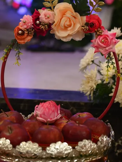 A close-up of the apple basket, showing the detail on the floral arrangement on the handle.