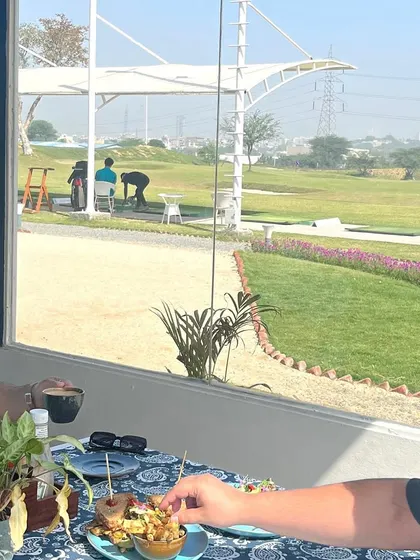 Enjoying coffee and snacks with a direct view of the golf action. Our café is designed to be part of the overall experience.