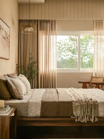 Here, light is filtered through linen curtains, framed by a custom pelmet with rhythmic grooves. The platform bed sits low, grounding the room in a meditative calm where materials become memories.