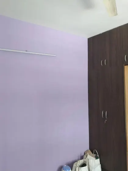 A soothing lavender-colored wall in a bedroom. This simple yet elegant color choice creates a calm and relaxing environment.