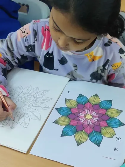 A student works on a beautiful mandala coloring sheet. This activity is not only creative but also very calming and helps improve focus.