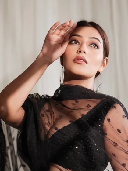 A cinematic and dramatic portrait inspired by the aesthetic of Sanjay Leela Bhansali films. The lighting and pose create a look of timeless elegance and mystique.