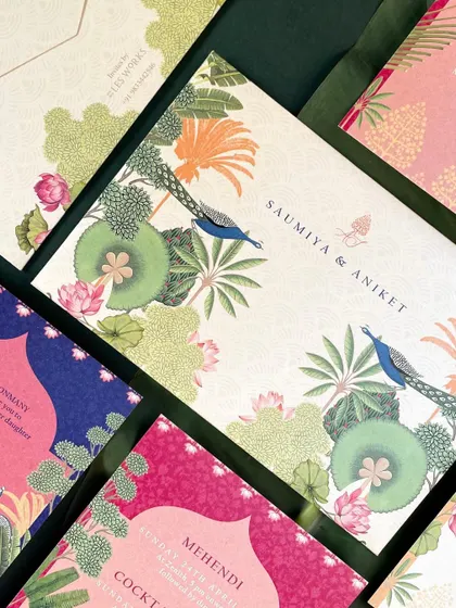 The main folder for the suite, featuring a stunning illustration of peacocks amidst a lush garden of lotus flowers and palm trees. This piece sets a grand and artistic tone for the entire wedding.
