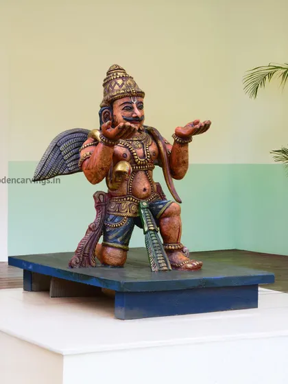 A colorful sculpture of Garuda, the divine eagle vahana of Lord Vishnu. This piece is often placed in front of a Vishnu or Balaji idol and is handcrafted with vibrant details.