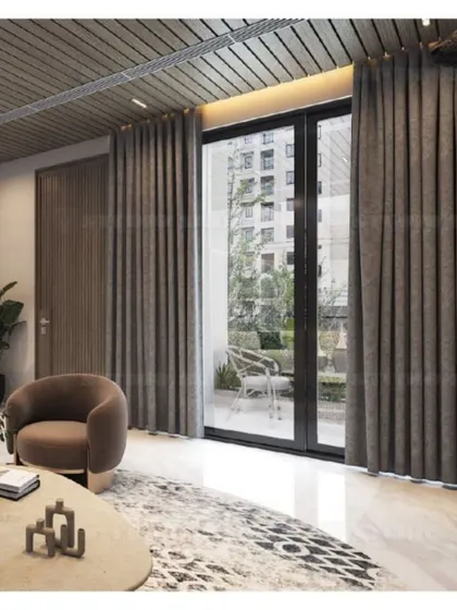 A view from the Mansarovar Garden lobby towards the balcony, showing how the dark, rich interiors are balanced by ample natural light.