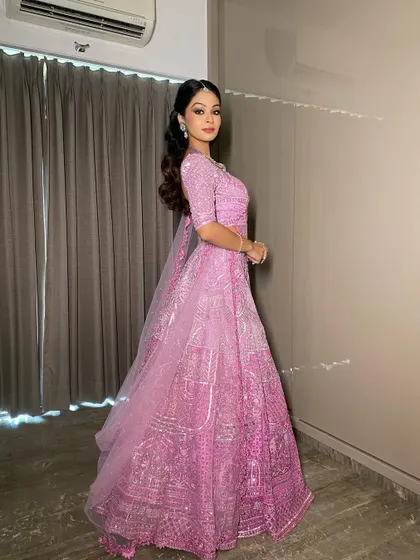 Another angle of this gorgeous pink sangeet look. The makeup is clean and precise, letting the bride's natural beauty and the vibrant outfit take center stage.