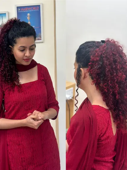 For this client, we embraced her beautiful natural curls with a fiery red balayage. The deep red tones are painted on to enhance the texture and volume of her hair, creating a bold yet elegant look, shown here styled in a high ponytail and also worn down.