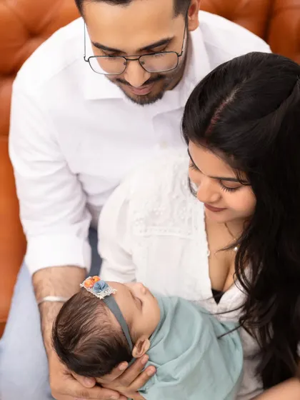 A beautiful high angle view of parents cherishing their newborn. This perspective creates an intimate portrait that emphasizes the baby as the center of their world.