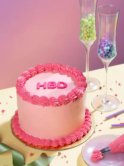 Introducing our "POP" cakes, designed to add a burst of colour to your celebrations. This mini message cake, with its bright pink frosting and "HBD" message, is a fun and modern way to say Happy Birthday.