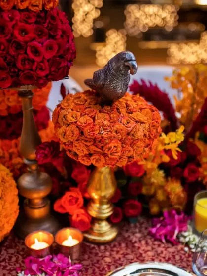 A close-up of a decorative bird on a sphere of orange roses. These small details add layers of meaning and artistry to our designs.