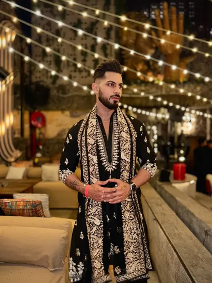 The combination of the embroidered kurta and matching shawl creates a rich, layered look that is perfect for a cool evening celebration during the festive season.