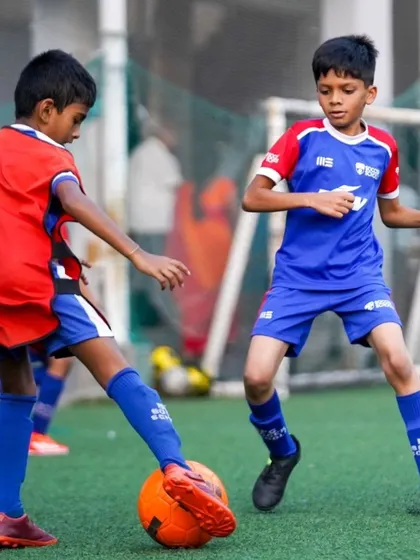 Two players from our Mathikere centre compete for the ball. We foster a competitive but respectful environment.