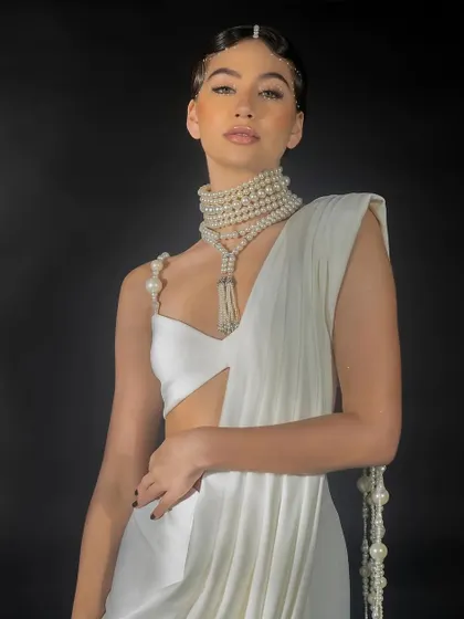 A close-up lookbook shot for Nikhil Thampi. The focus here is on the garment's neckline, the pearl shoulder detail, and the model's beauty look, creating a compelling image for social media and press.