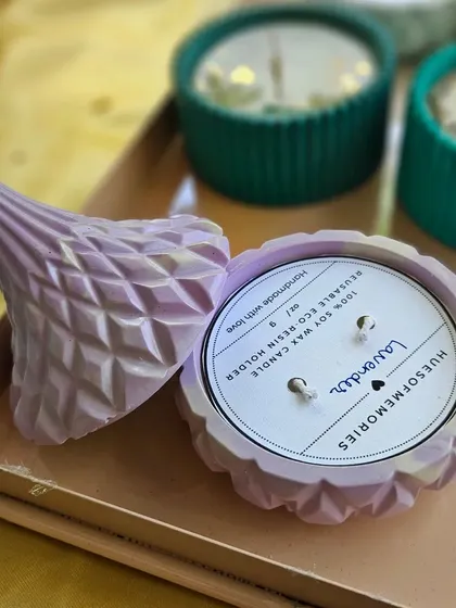 A beautiful lavender-colored diamond jar candle with its lid off, showcasing the double wick and clean soy wax pour. These make for a lovely gift or a treat for yourself.