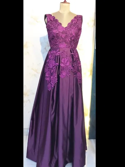 A classic wine-colored satin gown with beautiful lace applique work on the bodice and waist.
