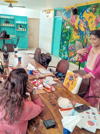 An art educator guiding participants during the "Awakening Shakti" watercolour workshop.