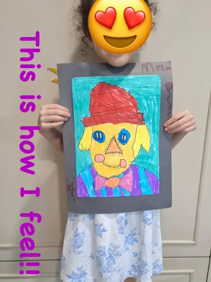 "This is how I feel!" This student's artwork of a scarecrow is a wonderful expression of her creativity. Holding up a finished piece she made herself is a huge confidence booster.
