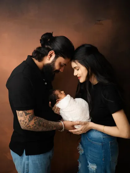 The beginning of a beautiful journey together. A classic family portrait showing the three of you, ready to start your new chapter.