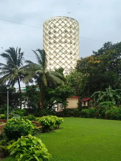 A view of the Nehru Centre from the adjacent park, showing how the monumental structure is integrated into its urban and natural context. The building stands as a testament to timeless public architecture.