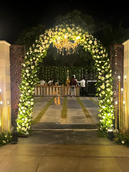 An outdoor floral archway leading to the bar area. This setup at the Crowne Plaza, Okhla, combines elegance with functionality, guiding guests through the beautifully decorated space.