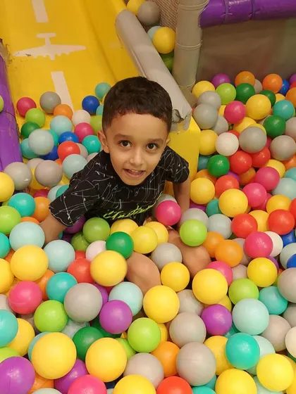 This little guy is having a great time in our clean and colorful ball pit. We ensure our play areas are always safe and hygienic.