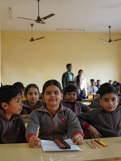 Students in school uniforms waiting for the competition to start.