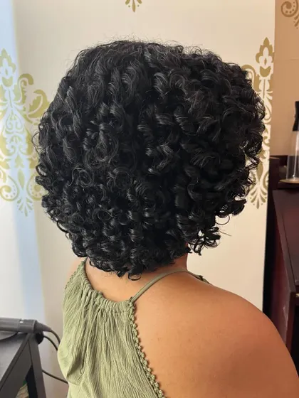 A close-up of the perfectly formed curls after a specialized cut.