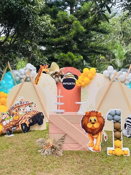 An outdoor safari setup featuring bright balloons, teepees, and friendly animal characters. We design our events to be engaging and fun for the little explorers.