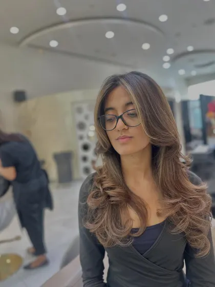 A beautiful color refresh with soft, face-framing layers. The subtle highlights add dimension while the cut gives the hair shape and bounce.