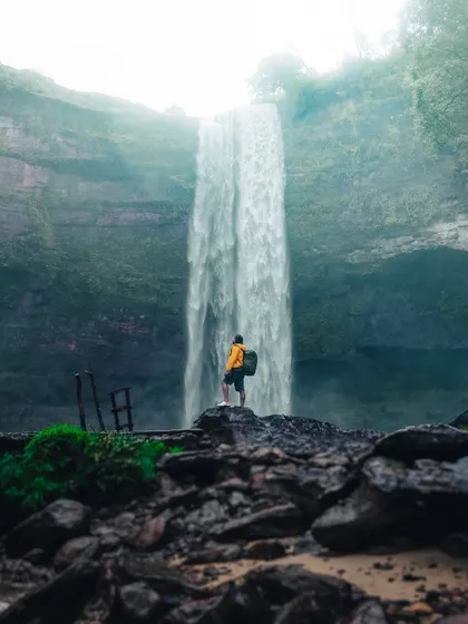 A self-portrait at the base of Phe Phe falls in Meghalaya, capturing the scale of the waterfall and the spirit of adventure.