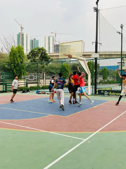 A player goes for a layup while a teammate celebrates in the background. This is the energy we love.