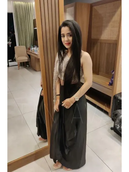 Chic and contemporary, this client is wearing a custom jet black drape skirt paired with a single-sleeve sequined crop top. It's a perfect outfit for a cocktail or sangeet night.