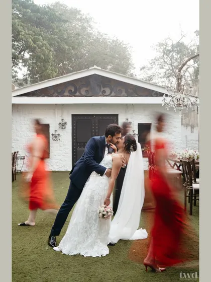 A creative shot using motion blur to focus on the couple's embrace. It creates a feeling that in a world of chaos, their love is the one thing that stands still and clear.