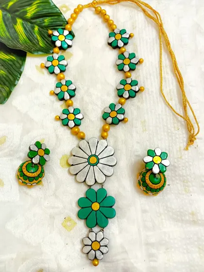 A classic white and green combination for the three-layer floral necklace. This elegant set is perfect for occasions like Onam or Independence Day.