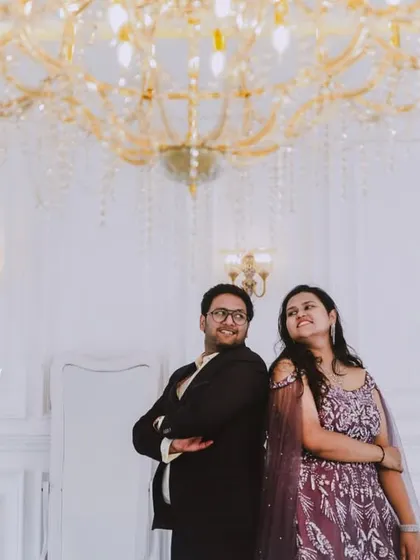 An all-white, classic European-style studio sets the stage for pure romance. The grand piano and crystal chandelier add a touch of musical elegance to this couple's pre-wedding photos.