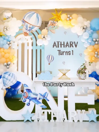A different angle of Atharv's hot air balloon-themed party, showing the full balloon arch and the custom "ONE" table that served as the centerpiece for his celebration.