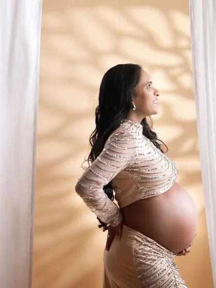 A profile shot in a sequined two-piece outfit, with beautiful shadow play from the studio lighting.