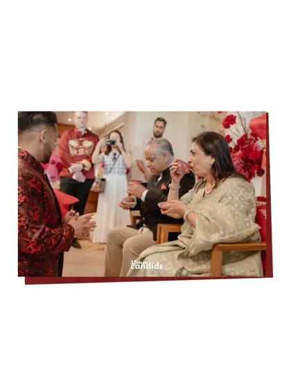 The tea ceremony continues, with the couple serving tea to the groom's parents. It’s a quiet moment of acceptance and the blending of two families.