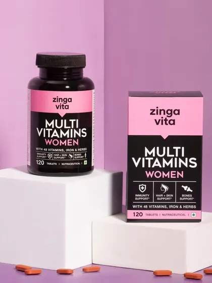 A modern, graphic shot of Zingavita's Multi Vitamins for Women. The use of geometric blocks and a purple color scheme creates a strong, contemporary brand image.