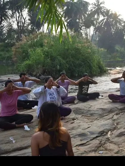Leading a Bhramari Pranayama (Bee Breath) session with a group by the river. Practicing in nature amplifies the calming and grounding effects of the breathwork.