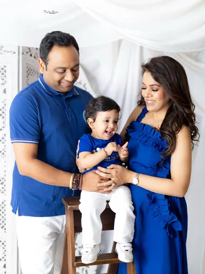 A candid family photo filled with laughter. The best family portraits are often the ones where everyone is relaxed and enjoying the moment together.