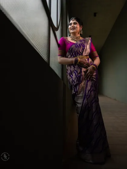 A full-length portrait of the bride-to-be, using the shadows and light of the corridor to create a sense of depth and elegance.