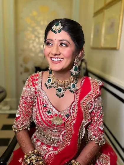 A radiant bride with her hair in a classic, neat bun. This timeless hairstyle is perfect for a traditional wedding look, ensuring all attention is on her beautiful smile and outfit.