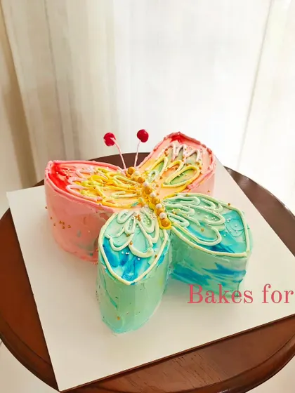 A beautiful butterfly-shaped cake with dragonfly details. The colorful, hand-painted wings make this a truly artistic and unique design.