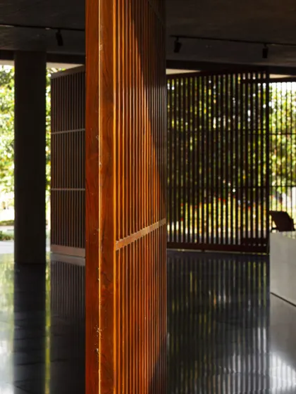 A close-up of the wooden screens, highlighting the craftsmanship and the warm, tactile quality of the material. These elements help to mediate the transition between interior and exterior spaces.