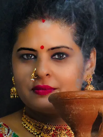 A powerful close-up portrait for Durga Pooja, with a bold red bindi and intense kohl-rimmed eyes, reflecting the strength of the goddess.
