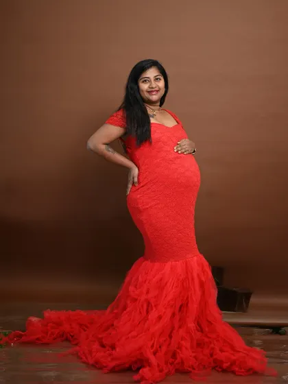 A confident and beautiful pose in the red mermaid gown. This style is perfect for moms who want to celebrate their curves during pregnancy.
