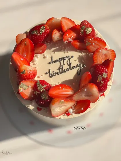 A seasonal favorite, this Vanilla Strawberry cake is topped with fresh strawberries, edible gold leaf, and tiny sugar pearls. It's available as a celebration cake or a smaller bento cake.