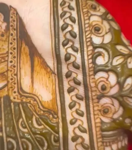 A close-up of the portrait from the previous image, showing the wet henna. You can see the fine lines and details even before the color sets.