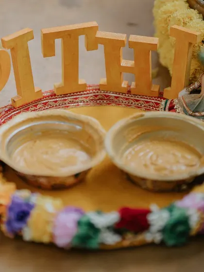 A decorated 'Pithi' tray holding the turmeric paste, ready for the auspicious ceremony.